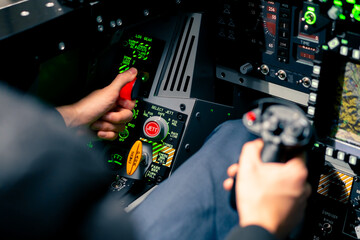 close-up of the cockpit of a military plane a pilot with a steering wheel and many buttons on the...