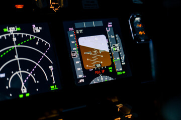 Close-up of an airplane cockpit Center panel with main flight display and navigation display...