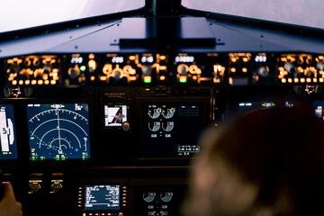 Close-up of an airplane cockpit Center panel with main flight display and navigation display...