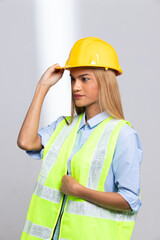 Female worker blonde hair lost her fingers from injured accident in industrial job. Woman engineer wear yellow hard hat show her lost fingers from work and insurance. White background isolated