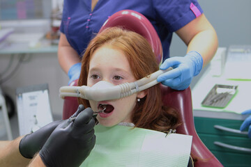 It is convenient for a little girl to treat her teeth under a superficial sedative. Treatment of...