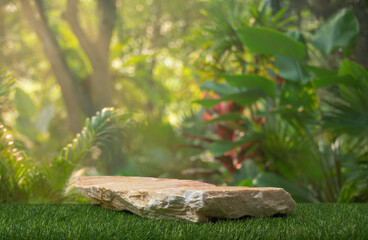 Stone tabletop podium floor in outdoors tropical garden forest blurred green leaf plant nature background.Natural product placement pedestal stand display,jungle paradise concept.