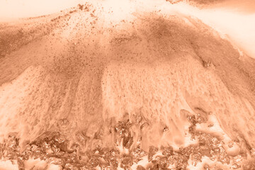Epoxy resin paint, abstract background. Demonstrating the colors of 2024 - Peach Fuzz.