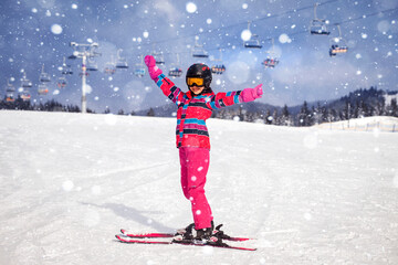 Ski for Children. Little Girl Child Skiing in Snow Suit in Winter Mountains on Snowy Hill,...