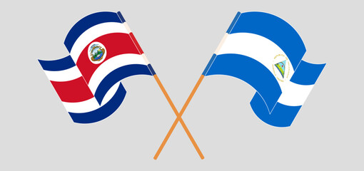 Crossed and waving flags of Costa Rica and Nicaragua