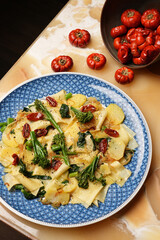 Vegetarian pasta with broccoli potato and tomatoes