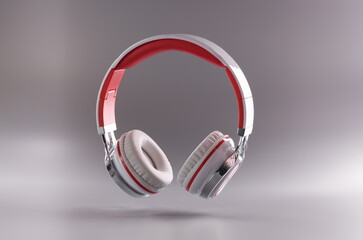 Close-up of high quality headphones in red and white colour combination floating in air on grey...
