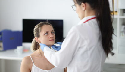 Doctor examining patients submandibular lymph nodes in clinic. Patient examination concept