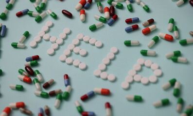 Help words made of white pills closeup. Medication treatment concept