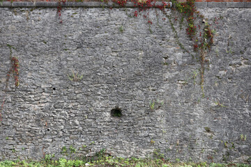 Very old brick stone wall of castle or fortress of 18th century. Full frame wall with obsolete dirty and cracked bricks close up