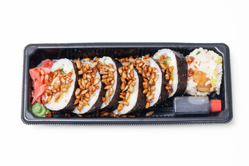 Takeaway sushi background. Sushi roll sprinkled with sunflower seeds. Japanese food isolated on white. Soy sos in plastic container. Sushi box isolated on white. Cutout sushi. Red marinated ginger.