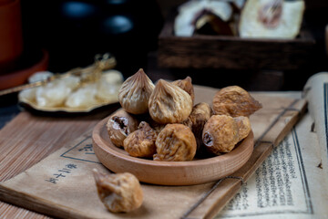 Dried figs and ancient books on the desktop