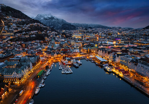 Aerial view of the city of Bergen, Bergenhus center district, Norway, during winter dusk time with snow and lights
