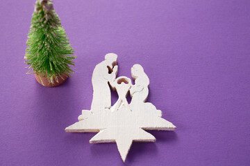 Wooden christmas creche on a wooden background. Christmas tree decoration