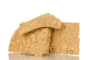 Three pieces of sweet halva, macro, isolated on white background.