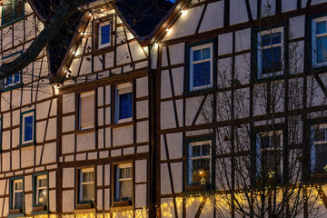 half-timbered houses with a string of lights