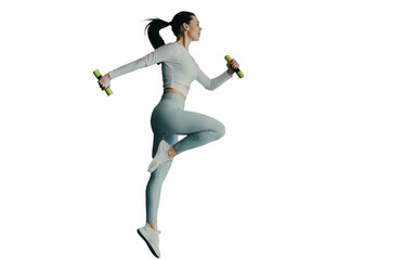 Fit caucasian young woman in blue sportswear makes jumps holds dumbbells against transparent background. Tall brunette European girl with ponytail doing sports. Healthy lifestyle.