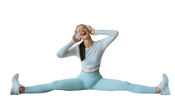 Happy brunette American girl in sportswear stretching at fitness using headphones sings song. Fit caucasian young woman enjoying training against transparent background, Youth, strength. Health