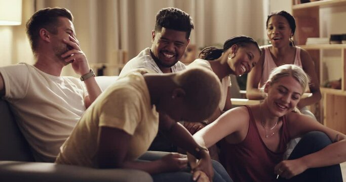 Conversation, laughing and group of friends in the living room with comic, funny or comedy joke. Happy, diversity and young people bonding, talking and chilling together in the lounge of apartment.