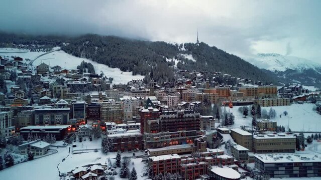 Switzerland St Moritz aerial drone footage in winter, lake city Alps covered by snow