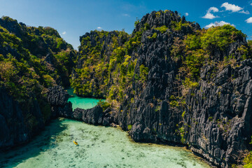 Secret lagoon in El nido. couple enjoying time in the crystal transparent water and kayaking....