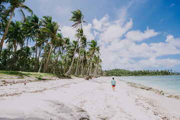 Man standing on the beach and enjoying the tropical place with a view. caribbean sea colors and...