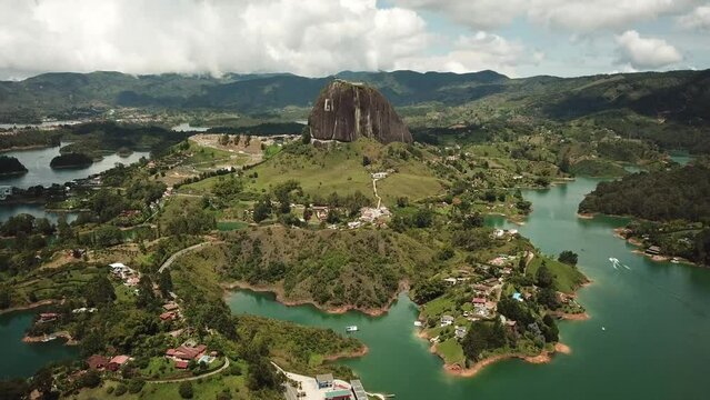 Aerial drone footage of El Penon de Guatape near Medellin in Antioquia, Colombia. Large and unique alone rock with stairs to the top, touristic place. Big stone in Colombia. High quality 4k footage.
