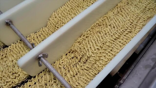 Production line. Macaroni factory. Noodle conveyor. Automated food factory. Production of instant noodles. Fast food. Noodle factory.