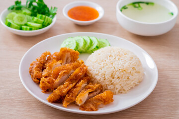Hainanese chicken rice with fried chicken or oily rice with fried chicken and chili sauce