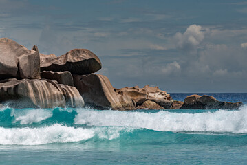 Waves at Grand Anse Beach,  La Digue, The Seychelles. Huge granite rocks and turquoise water.