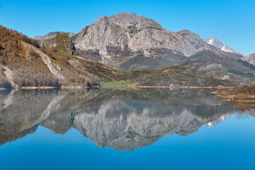 Beautiful reservoir and mountain landscape in Riano. Mirror effect. Spain