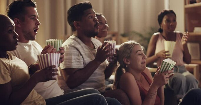 Friends, group and scary movie with popcorn jump on sofa or watching thriller, spooky film or horror bonding. Man, woman, and shock together in home or streaming entertainment, weekend or surprise
