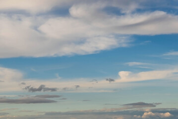 Blurred image of a blue sky with different clouds.