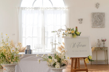 Welcome to wedding sign and reception table decorated with flowers