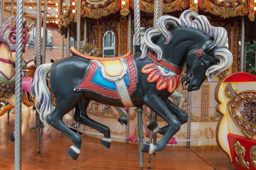 black wooden horse on a carousel in a square at Christmas in Madrid. Spain