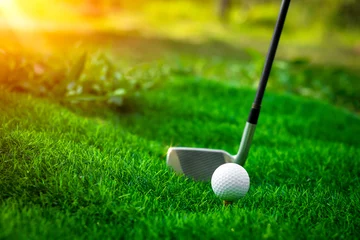 Fotobehang Golf ball close up on tee grass on blurred beautiful landscape of golf background. Concept international sport that rely on precision skills for health relaxation.. © Sittipol 