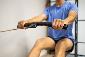 Man exercising with a rowing machine at the gym
