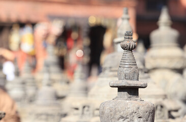 the small buddha atop with background of thousand of atops in Swayambhunath, nepal