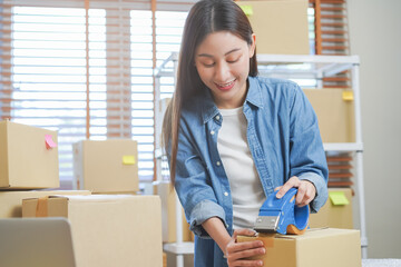 Small business entrepreneur SME, asian young woman,girl owner packing product, checking parcel for...