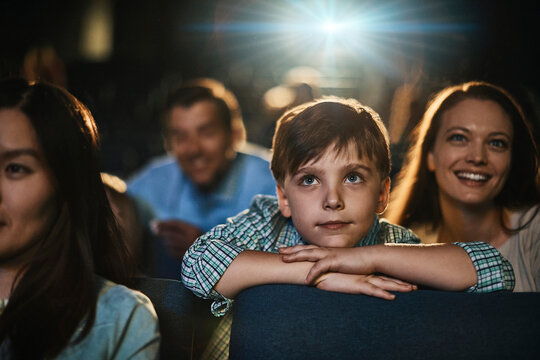 Boy watching a film in movie theater