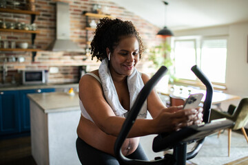 Pregnant woman exercising on bike at home