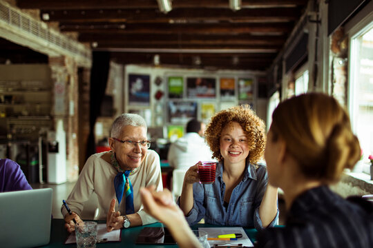 Diverse businesswomen working on project together in modern office