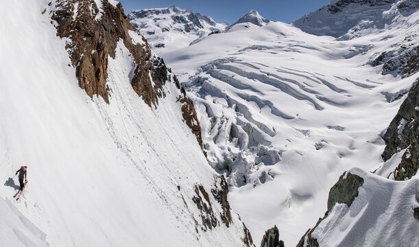 From above of unrecognizable Skier Descending a Steep Glacier Ridge in Zermatt