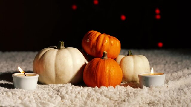 Autumn pumpkins with candles in warm background