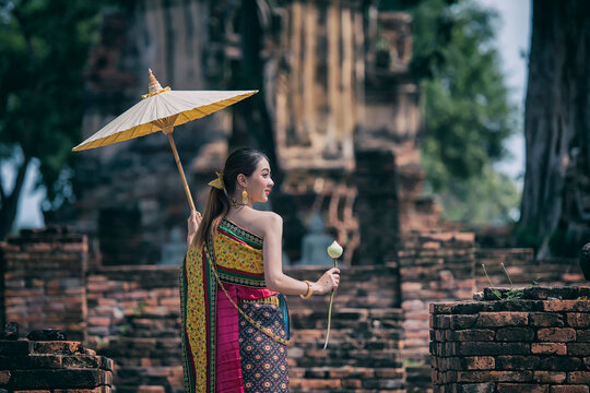 Woman With Umbrella. Women In Traditional Clothing  On Buddhist On Background.  Portrait Women In Traditional Clothing , Thai Traditional  In Ayutthaya, Thailand.