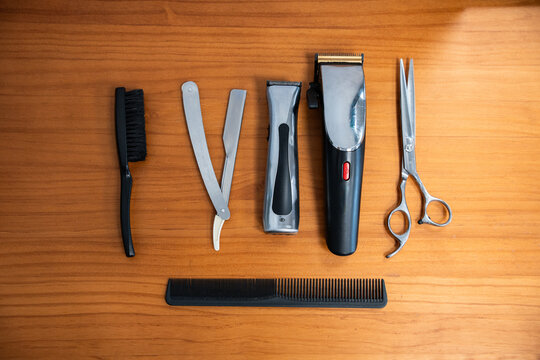 Various barber tools arranged on wooden table