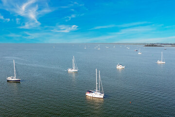 Aerial from anchored sailing ships on the IJsselmeer on a hot summer day in the Netherlands