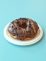 Chocolate oreo and peanut butter donut on plate