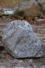Fototapeta na wymiar big decorative granite boulder field stone for garden or tombstone in cemetery