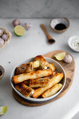 Turkish Cigara Börek (Sigara böreği) or Cigarette Pastry with Spinach and Feta Cheese with yogurt dip. Finger food. Spring rolls.